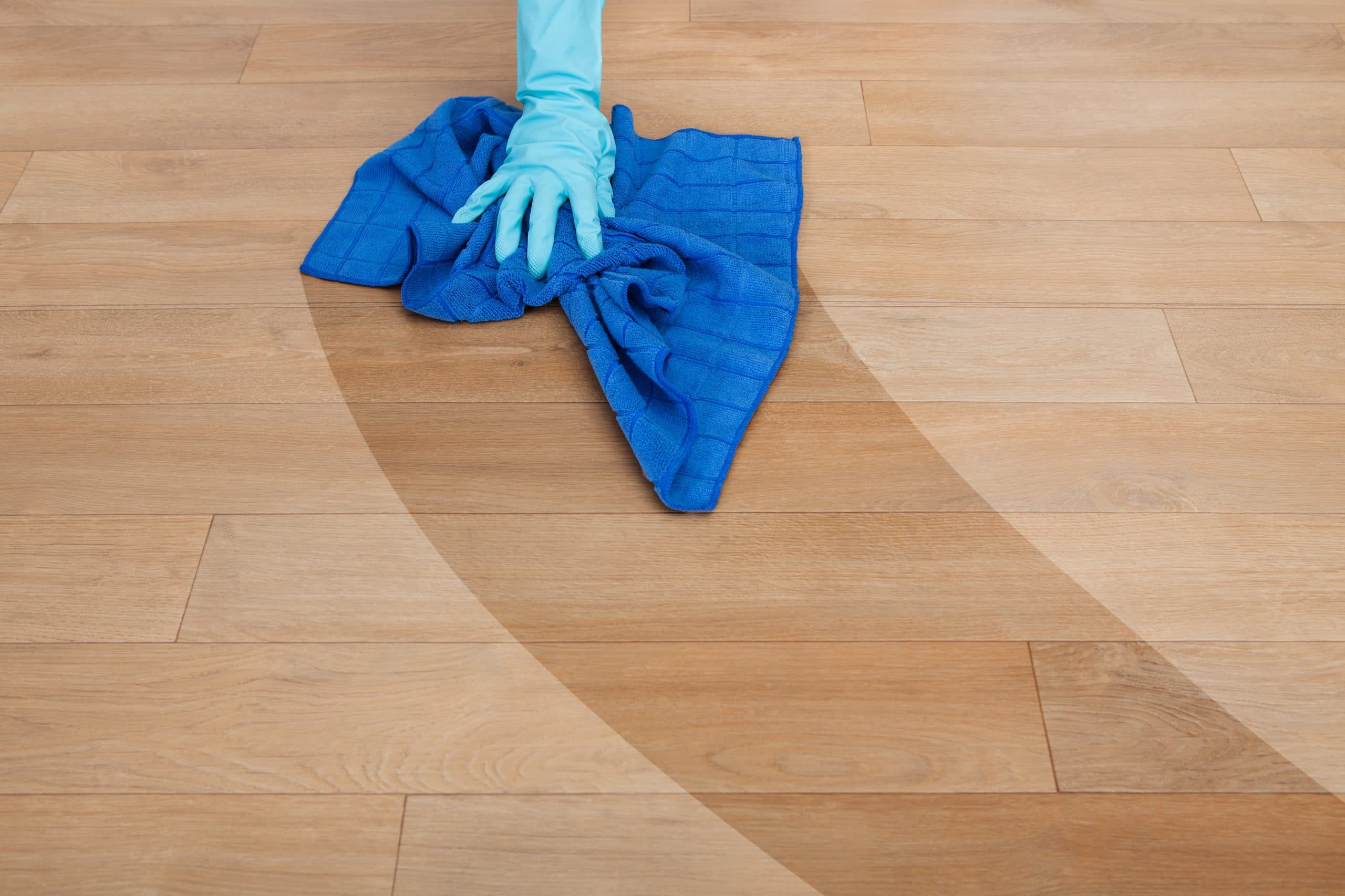 Dry cleaning a hardwood floor with a cloth